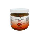 Jar of precut kimchi with a white lid on a white background