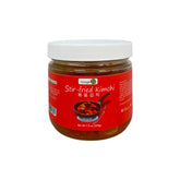 Jar of stir-fried kimchi with a red label on a white background