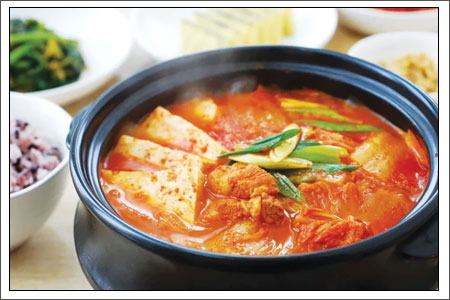 Kimchi Jjigae boiling in a traditional Korean stone pot